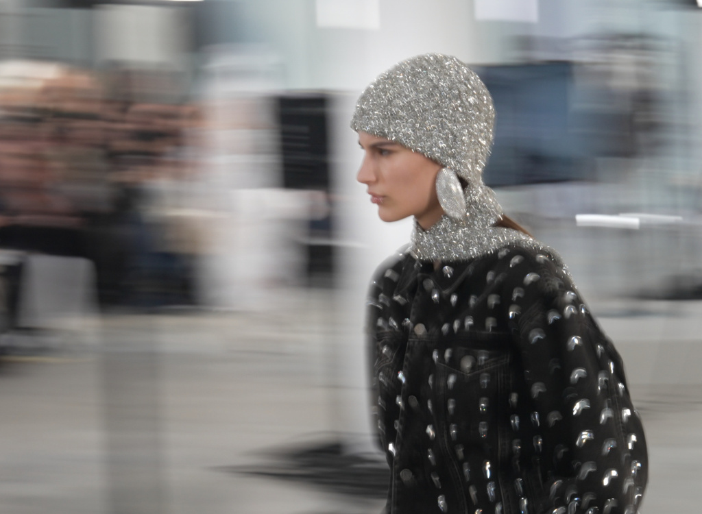 Professional videographer filming models on runway during Milan Fashion Week show Fashion photographer capturing haute couture looks at Milan fashion show Camera crew documenting luxury designer collection on illuminated Milan runway Videographer with professional equipment recording backstage at Milan fashion event Fashion media photographer crouched beside catwalk during Milan Fashion Week Cinematographer capturing dramatic runway lighting at evening Milan fashion show Professional camera operator filming model poses during prestigious Milan fashion event Fashion photographer using telephoto lens to capture designer garments on Milan runway